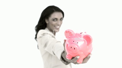 Businesswoman holding piggy bank