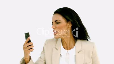 Businesswoman screaming down her mobile phone