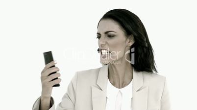 Businesswoman screaming down her mobile phone in black and white