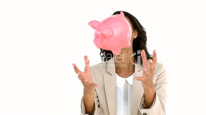 Businesswoman catching piggy bank
