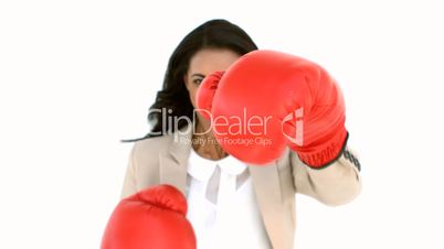 Businesswoman boxing at the camera
