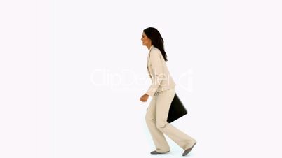 Businesswoman jumping in the air with her suitcase