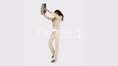 Businesswoman jumping and holding her suitcase