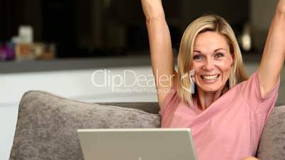 Blonde woman happy winning online