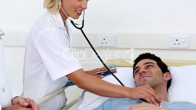 Doctor examining patient with stethoscope