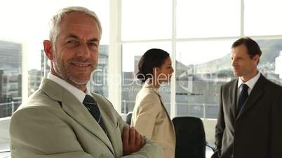 Confident businessman standing in office