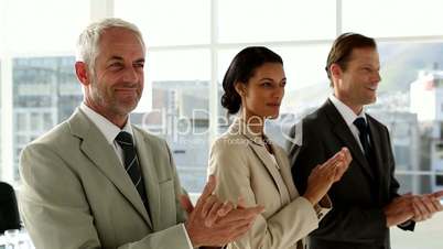 Business team clapping in office