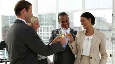 Business people celebrating with champagne and chatting