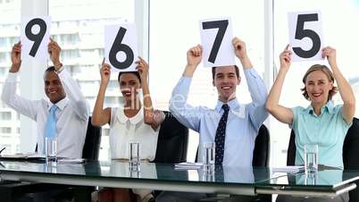 Business people showing scores