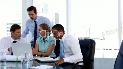 Business people using a laptop during meeting