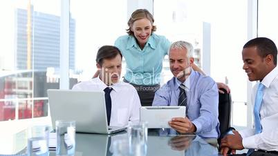 Group of business people using laptop and tablet computer
