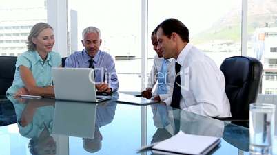 Group of business people using tablet computer and laptop