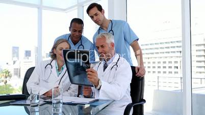 Group of doctors examining an x-ray together