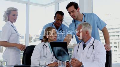 Group of doctors examining an x-ray