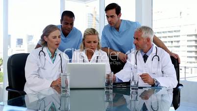 Group of doctors using a laptop together