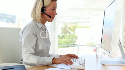 Businesswoman talking with someone on her headset