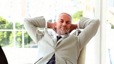 Confident businessman relaxing on his chair