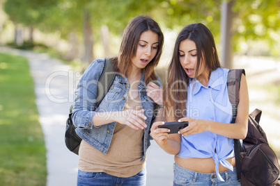 Young Adult Mixed Race Twin Sisters Sharing Cell Phone Experienc