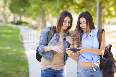 Young Adult Mixed Race Twin Sisters Sharing Cell Phone Experienc