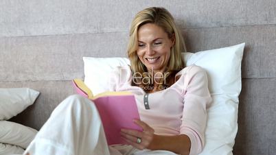 Blonde woman enjoying a book