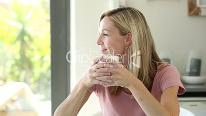 Blonde woman enjoying her drink