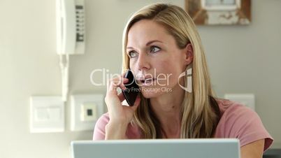 Frustrated woman shaking her head while she is on the phone