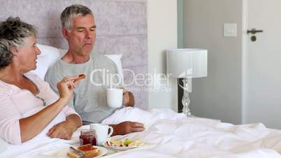 Mature couple having a breakfast in the bed