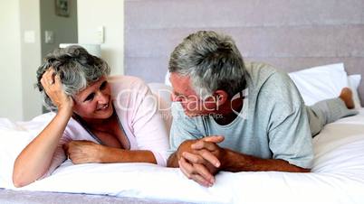 Mature couple talking each other on the bed
