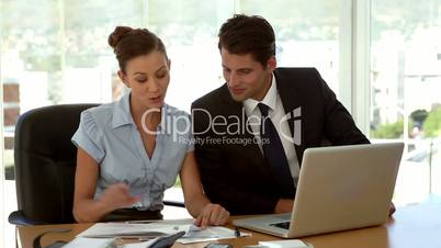 Business people examining a document in their office