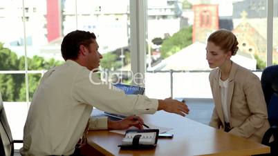 Applicant signing an agreement at the end of a job interview