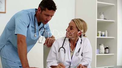 Doctors examining a document together