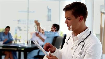 Young doctor using tablet computer