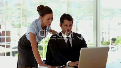 Businesswoman helping a colleague