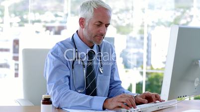 Smiling doctor working in office