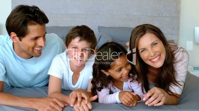 Family lying on a bed