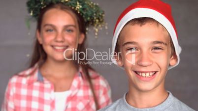 Smiling siblings with christmas hat