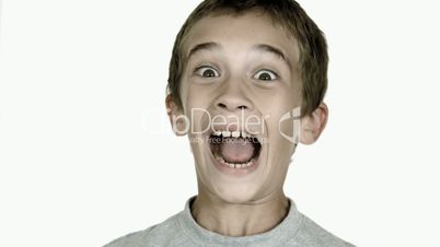 Boy grimacing against white background