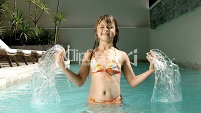 Young girl splashing water in her head