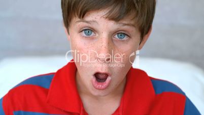 Surprised blue eyed boy opening his mouth 