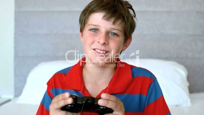 Concentrated young boy playing video games