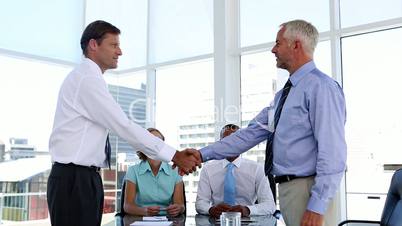 Businessmen shaking hands in the meeting room