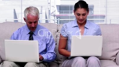 Business people working on laptops