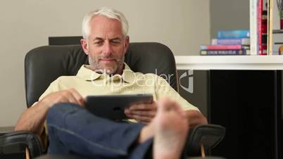 Man relaxing with his tablet
