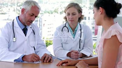 Doctors explaining something to patient