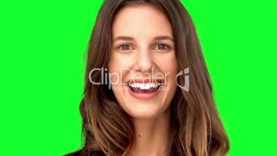 Surprised woman smiling on green screen