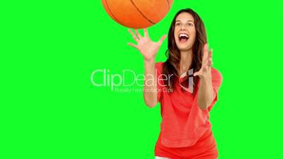 Woman catching a basketball on green screen