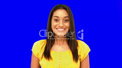 Cheerful woman being surprised on blue screen