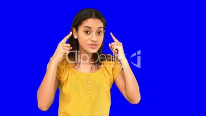 Woman pointing  to her temples on blue screen