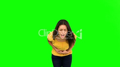 Woman suffering from belly pain on green screen