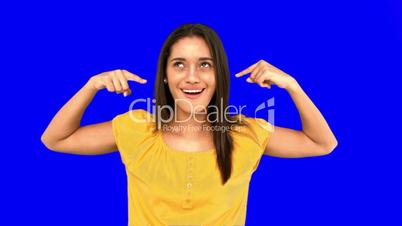 Woman making crazy gesture on blue screen